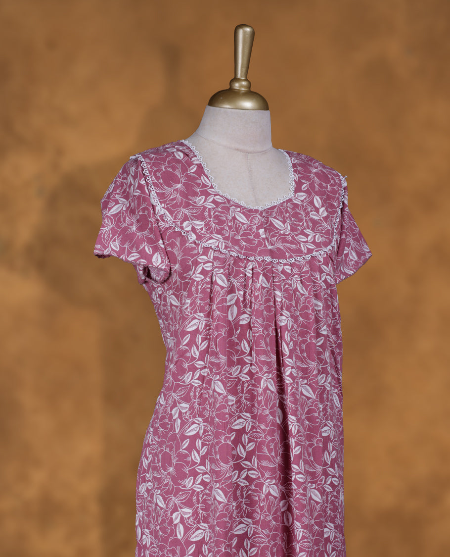 Pink colour NStyle nighty featuring white floral patterns, a round neckline with lace trim detailing, short sleeves, and a full ankle-length design.