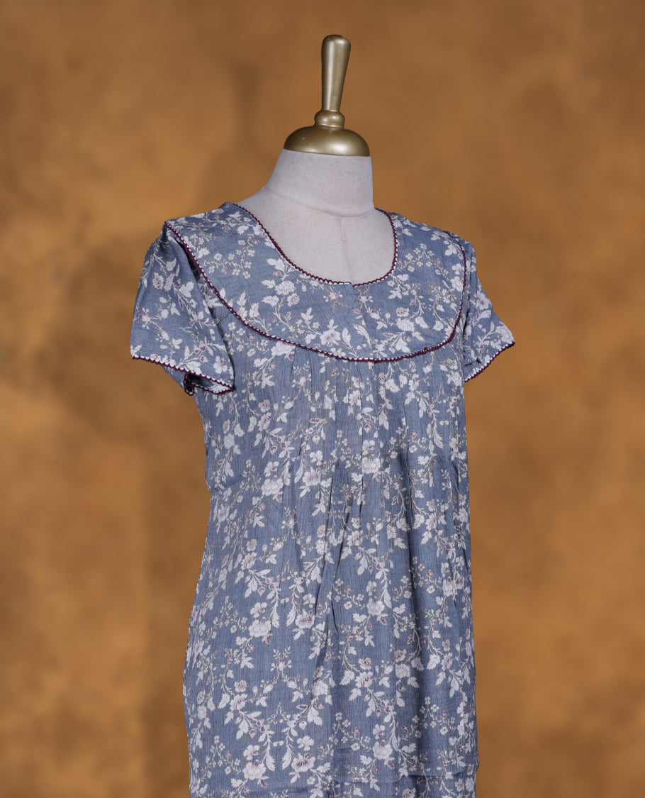 blue gray colour NStyle nighty featuring white floral patterns, a round neckline with maroon piping detailing, short sleeves, and a full ankle-length design.