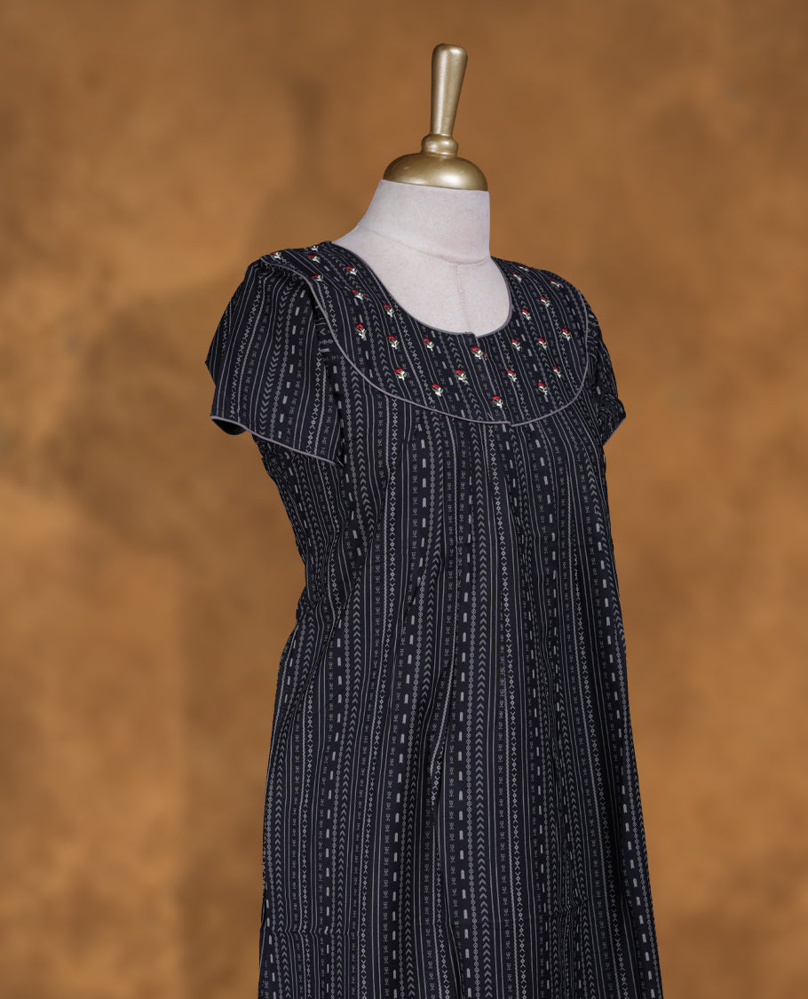 Black colour NStyle nighty featuring gray geometric pattern, coloured floral patterns on a U neckline with gray colour pipe details , short sleeves, and a full ankle-length design.