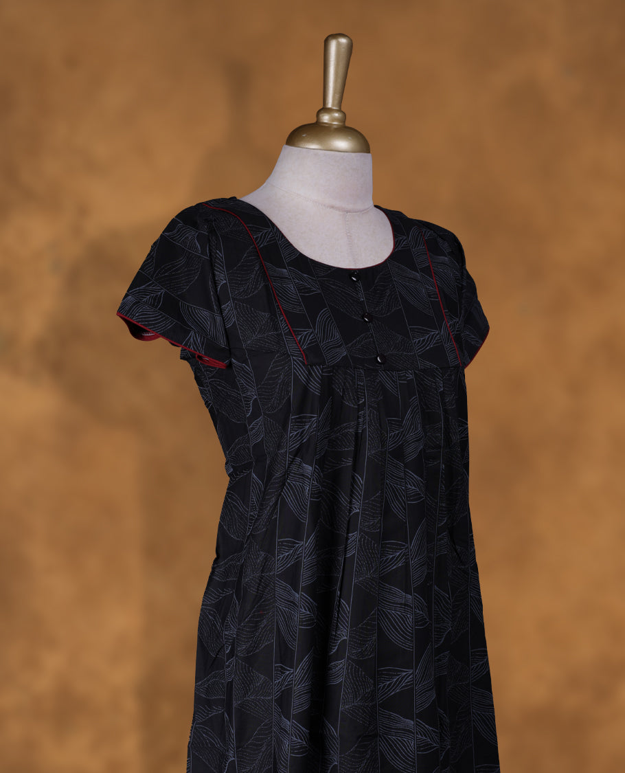 Black colour NStyle nighty featuring gray floral patterns, a U-neckline with lace detailing, short sleeves, and a full ankle-length design.