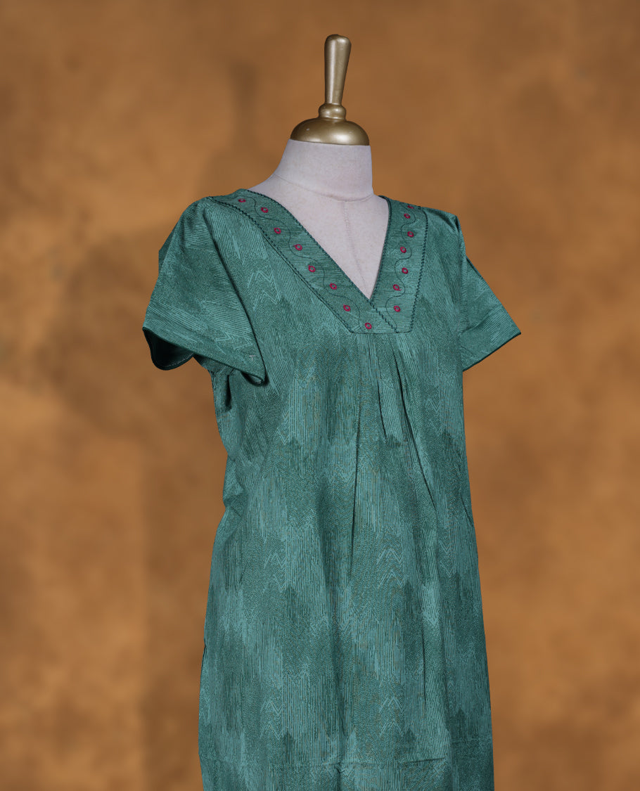 Aqua green colour NStyle nighty featuring dark green patterns, a V-neckline with thread detailing, short sleeves, and a full ankle-length design.