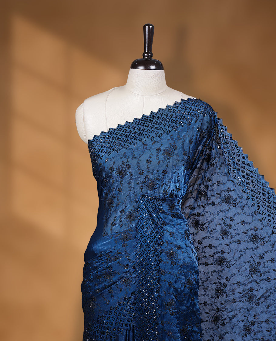 Dark Blue colour velvet chiffon designer saree, featuring black thread embroidery kodi pattern on body, black cut stone work and heavy stone border, pallu and Paired with matching blouse.