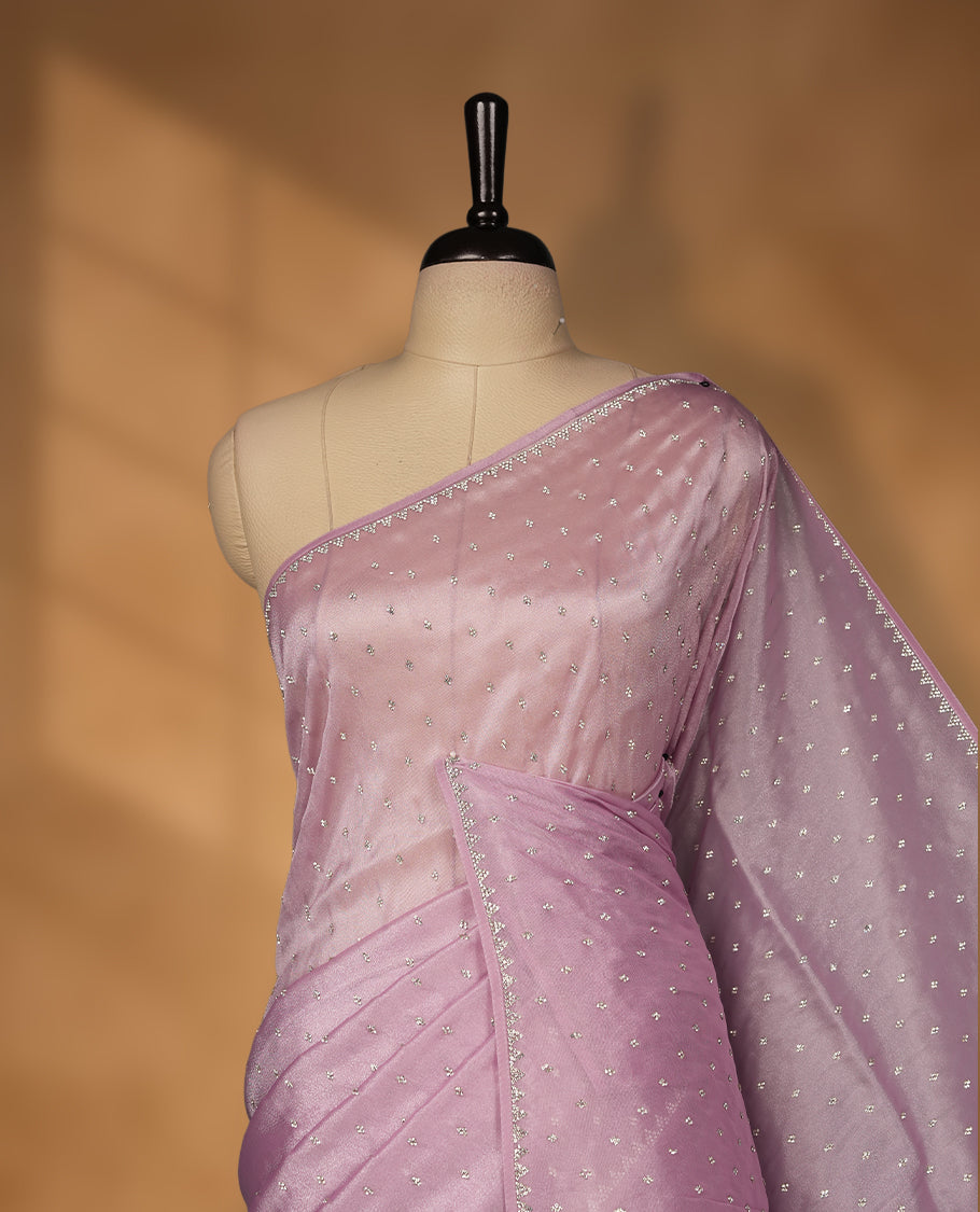Light Purple Colour net shimmer fancy saree adorned with white stone buttas all over the body, paired with a delicate stone worked border and matching blouse