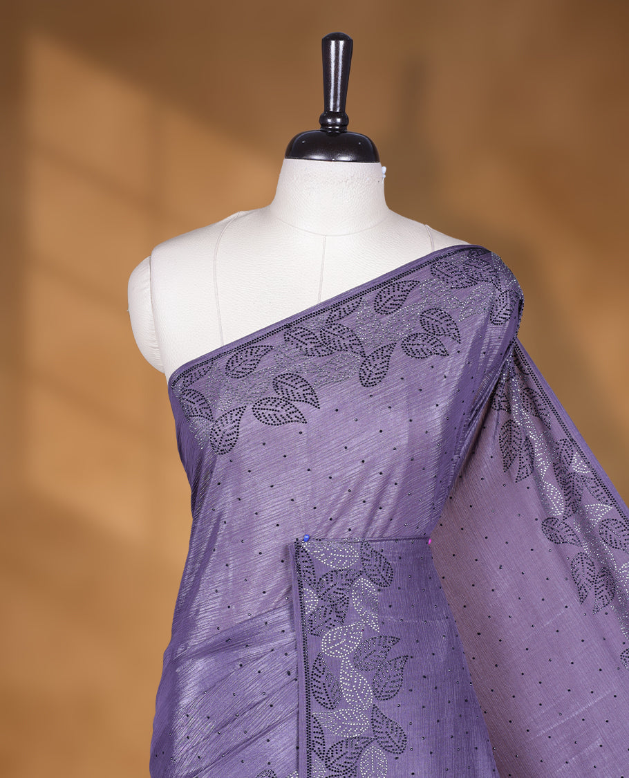 Dusty purple colour chiffon designer saree, featuring black and white scattered stone on body, stone work and heavy stone leaf pattern on border and pallu, Paired with matching blouse.