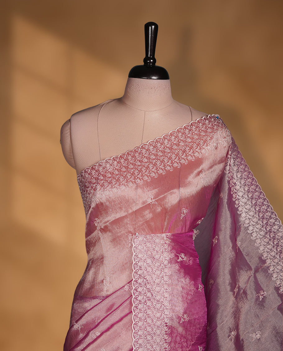 Pastel Mulberry colour net organza saree featuring white thread embroidery motifs on body and thread detailing on the border and paired matching blouse.