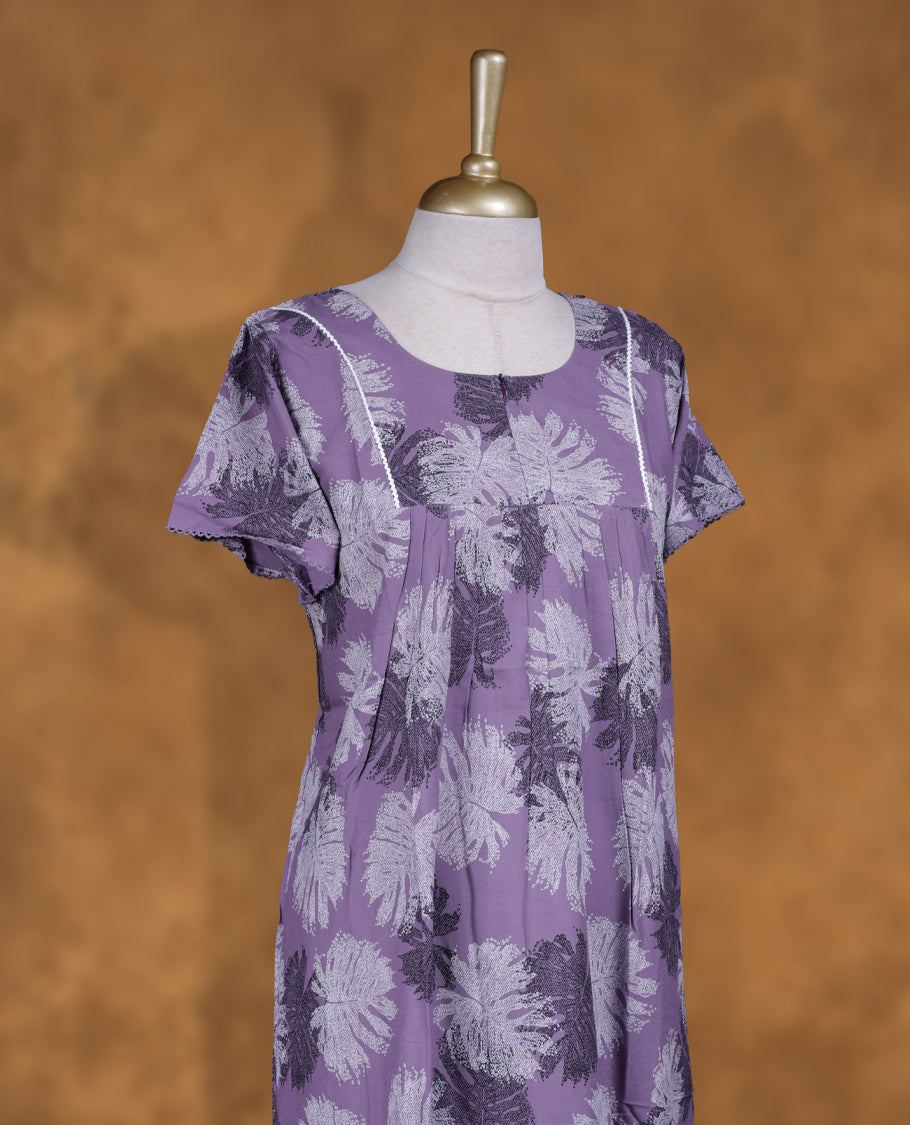 lavender colour NStyle nighty featuring Black and White Leaf patterns, a Round neckline and thread border, short sleeves, and a full ankle-length design.