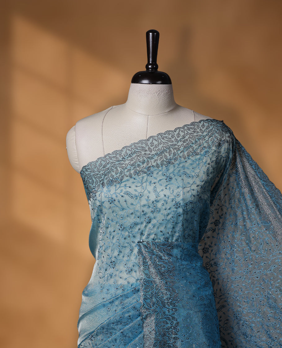 Light blue colour velvet chiffon designer saree, featuring self colour thread embroidery kodi work on body, stone work and all over motifs on border and pallu, Paired with matching blouse.