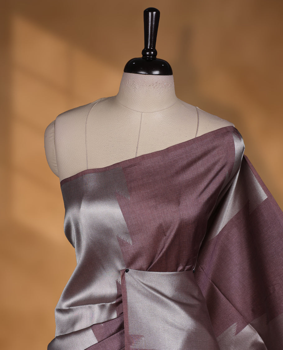 Brown and brown silver dual tone semi tussar saree featuring woven abstract geometric motifs on the body, complemented by a ikat inspired patterned pallu, paired with a matching blouse.