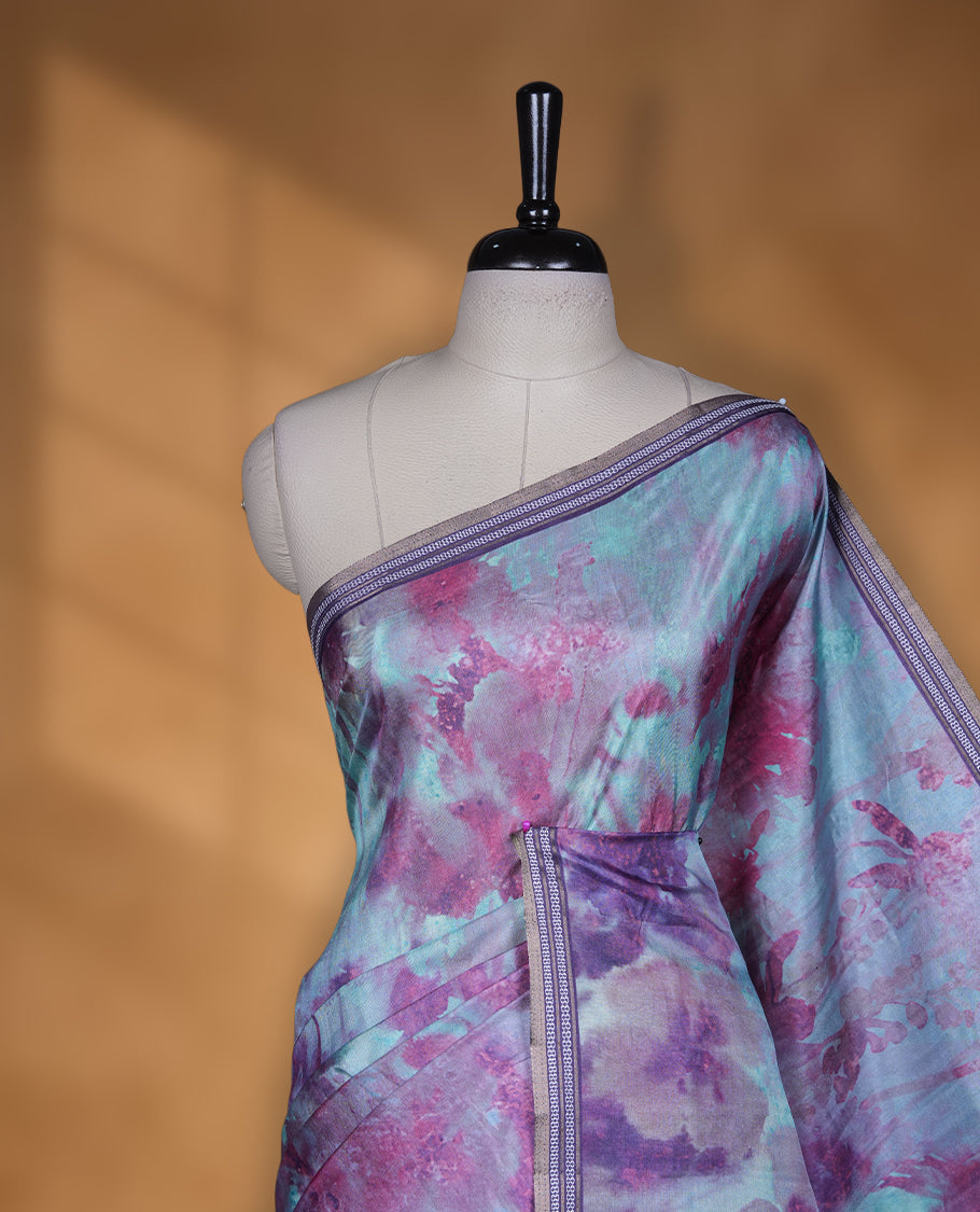 Aqua green colour semi tussar silk saree featuring an abstract digital floral printed body with a rich purple self border and tasselled pallu, paired with a matching blouse.