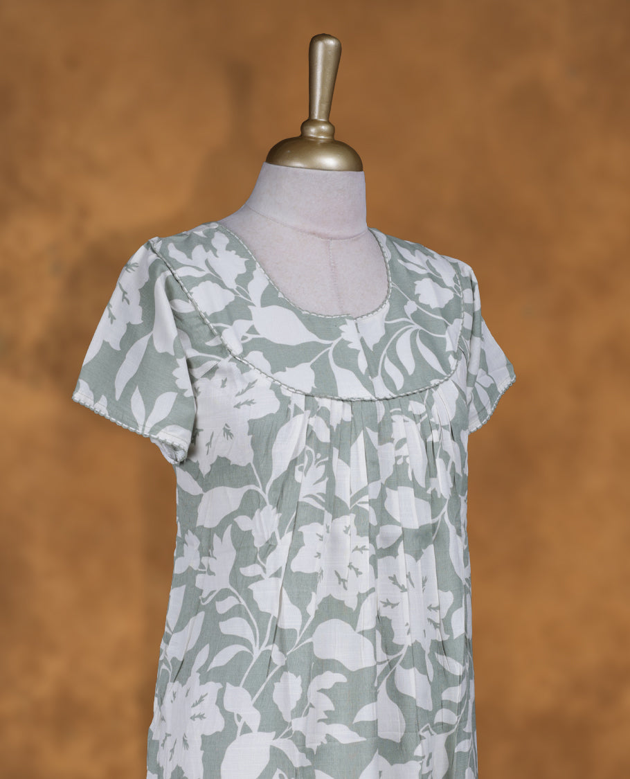 Dark sea green colour NStyle nighty featuring Offwhite Leaf patterns, a Round neckline and thread border, short sleeves, and a full ankle-length design.