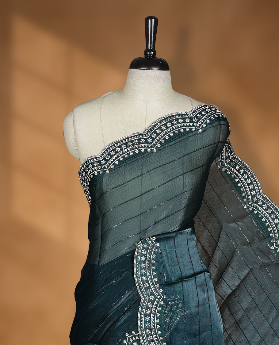 Dark green colour chiffon designer saree, featuring self colour beats stripes on body, heavy gold stone patttern on border and pallu, Paired with matching blouse.