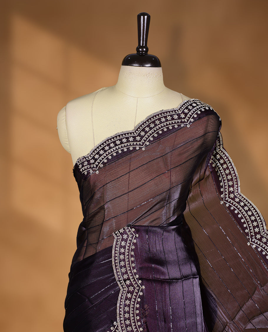 Dark Grape colour chiffon designer saree, featuring self colour beats stripes on body, heavy gold stone patttern on border and pallu, Paired with matching blouse.