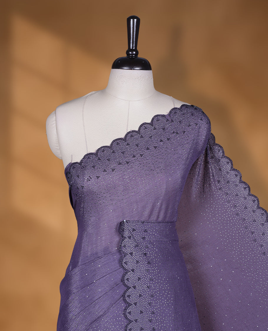Dark pastel purple colour chiffon designer saree, featuring black and white scattered stone on body, stone work and heavy stone pattern on border and pallu, Paired with matching blouse.