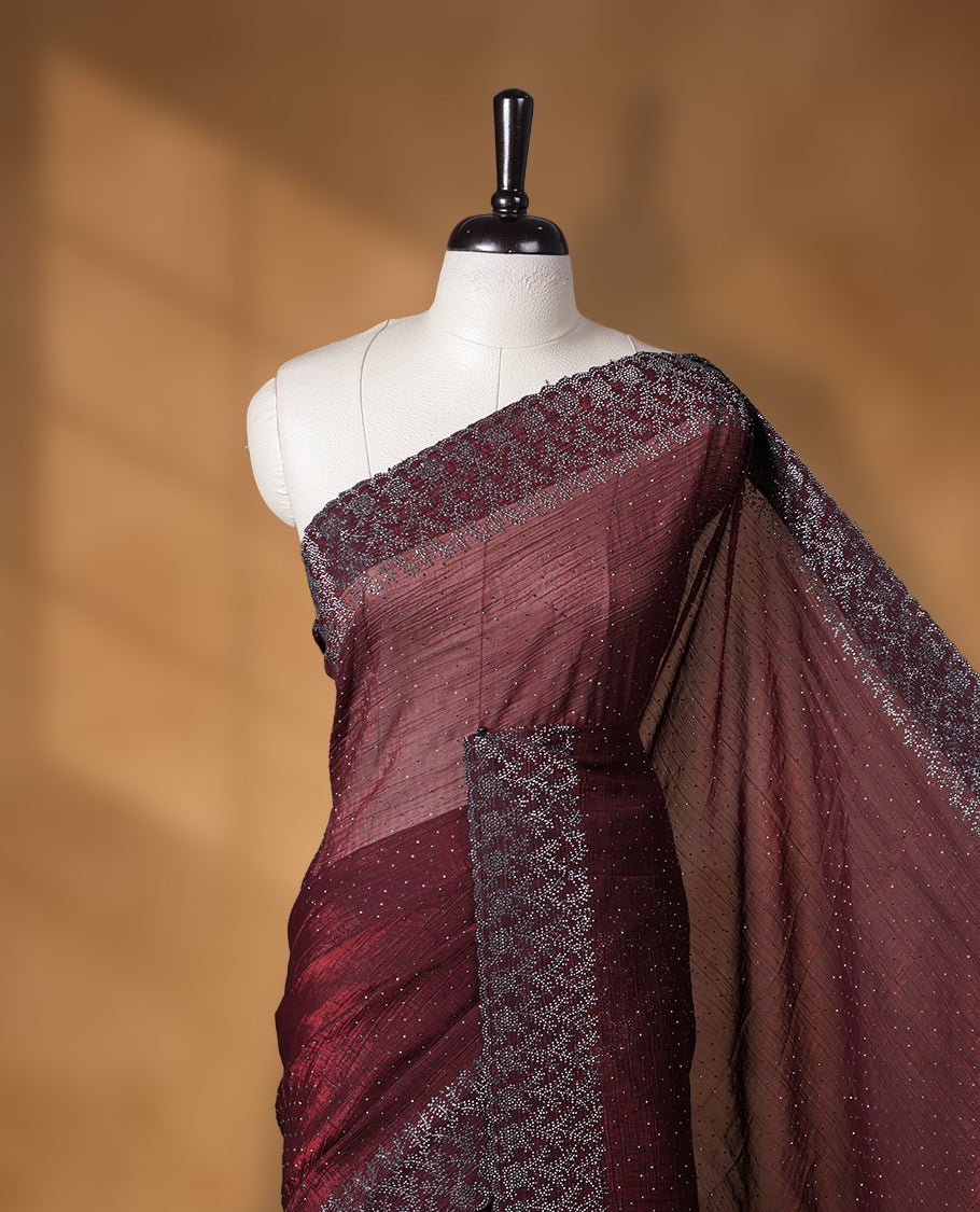 Chocolate brown colour chiffon designer saree, featuring white stone all over on body, heavy stone patttern on border and pallu, Paired with matching blouse.
