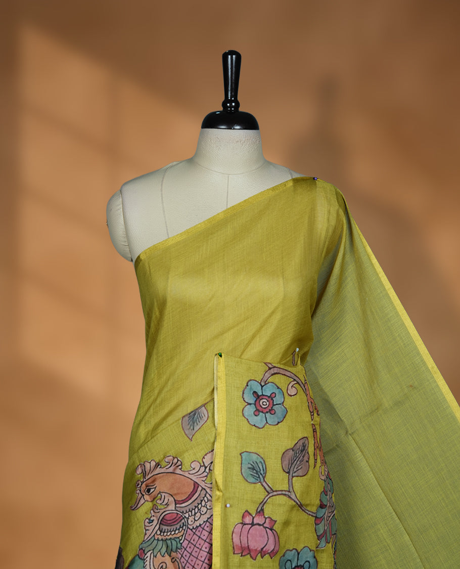 Lime green semi linen saree featuring hand painted floral and bird motifs across the pallu and border finished with subtle tassel detailing and paired with a matching floral print blouse