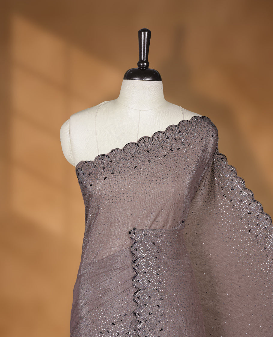 Dusty brown colour chiffon designer saree, featuring black and white scattered stone on body, stone work and heavy stone pattern on border and pallu, Paired with matching blouse.