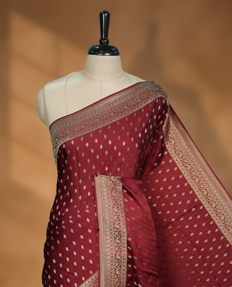 Maroon Colour semi Banaras satin crepe saree with Gold Zari Buti Motifs, Traditional Gold Geometric Pallu, Elaborate Woven Border, Decorative Tassels with Matching Blouse
