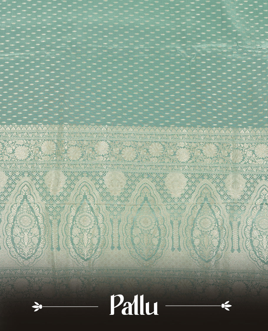 Pastel aqua colour banaras satin crepe saree fearturing gold tiny leaf motifs on body, kodi visiri pattern on border & pallu and paired with matching blouse