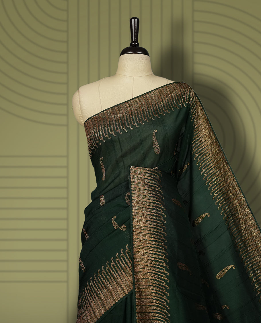Dark green colour semi Banarasi Tussar Georgette saree with delicate gold zari buttas on the body, a rich golden zari pallu, and detailed woven border & Comes with a matching blouse piece.