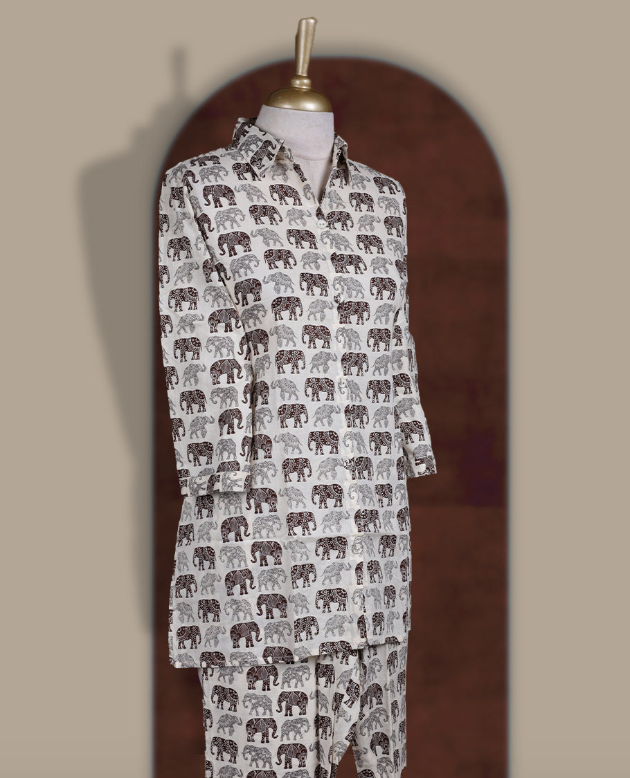 Off white colour cotton coord set featuring charming brown & grey colour elephant prints all over, Designed with a classic shirt collar and 3/4 sleeves, paired with matching straight pants for a trendy, relaxed, and comfy everyday look.