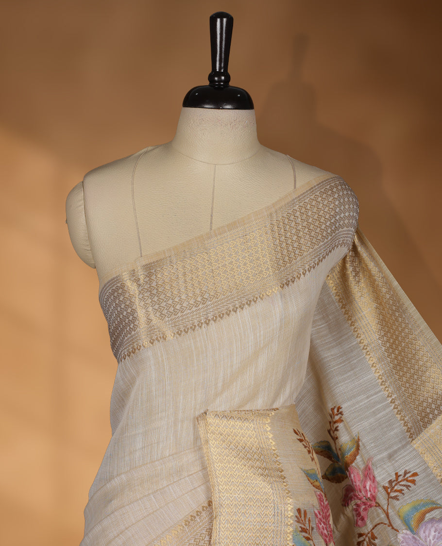Beige colour Banarasi linen silk saree featuring hand brushed colour with Floral & birds printed pattern on body, gold zari woven geometric design border with self colour pallu and comes with a matching blouse
