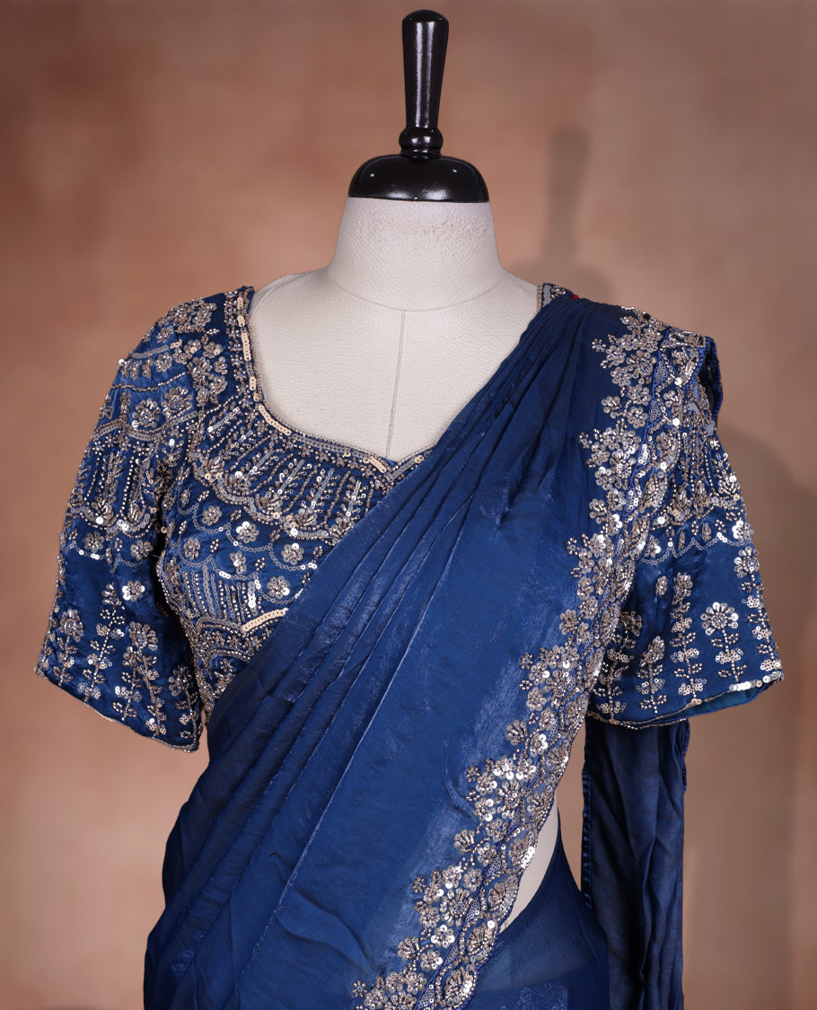 Elegant Dark teal colour ready to wear saree adorned with rich silver bead embroidery along the border and pallu, paired with a heavily embellished matching blouse for a grand festive look.