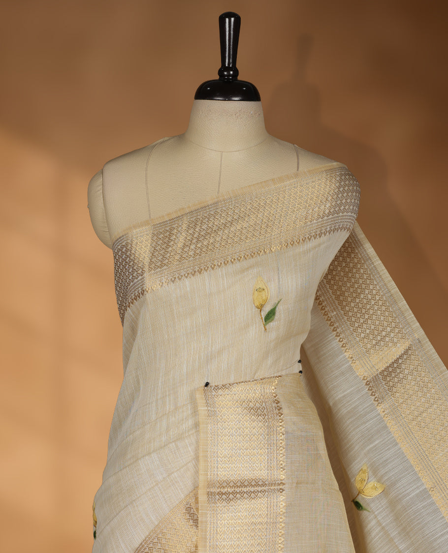 Beige colour linen silk saree featuring hand brushed colour with Floral & birds printed pattern on body, gold zari woven geometric design border with self colour pallu and comes with a matching blouse