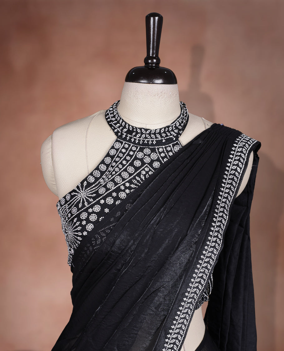 Elegant Black colour ready to wear saree adorned with rich silver stone embroidery along the border and pallu, paired with a heavily embellished matching blouse for a grand festive look.