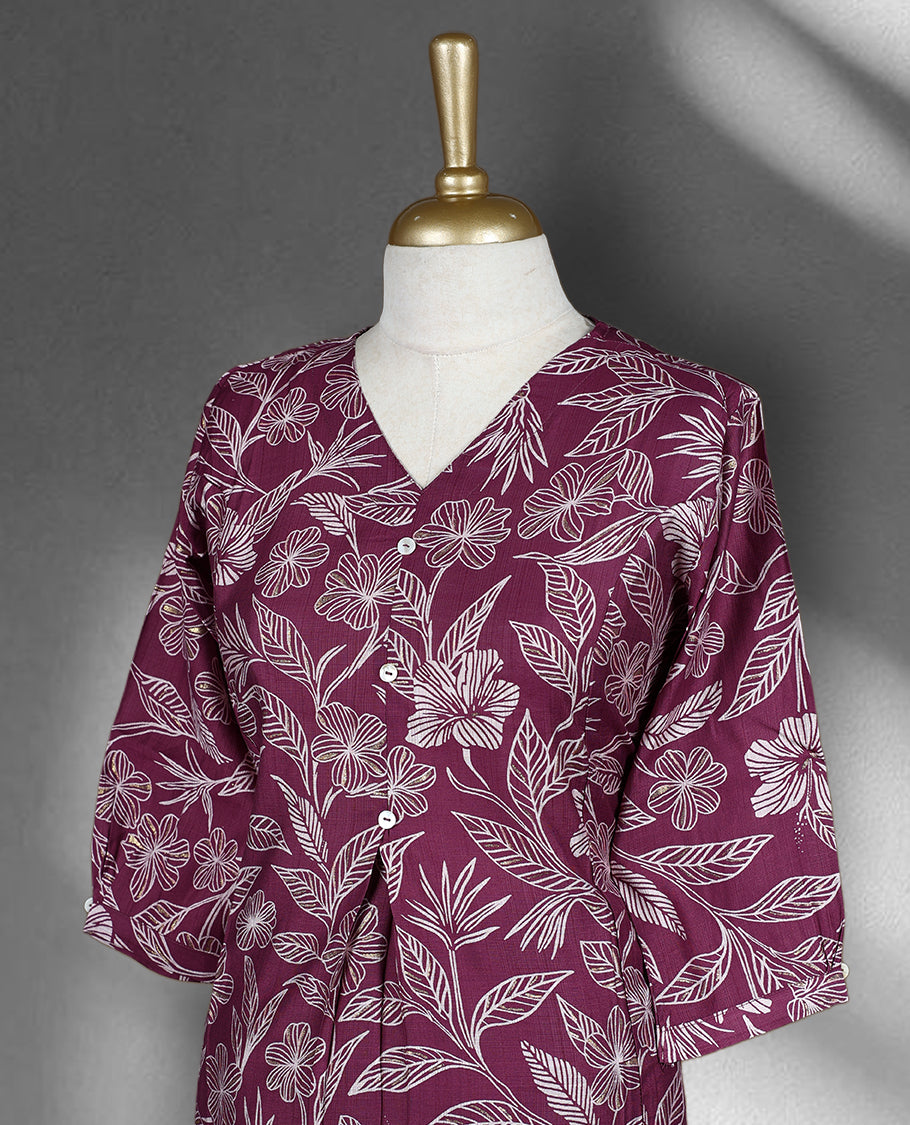 Onion pink colour cord set featuring a floral printed top with a V neck and button detailing, paired with solid onion pink pants.
