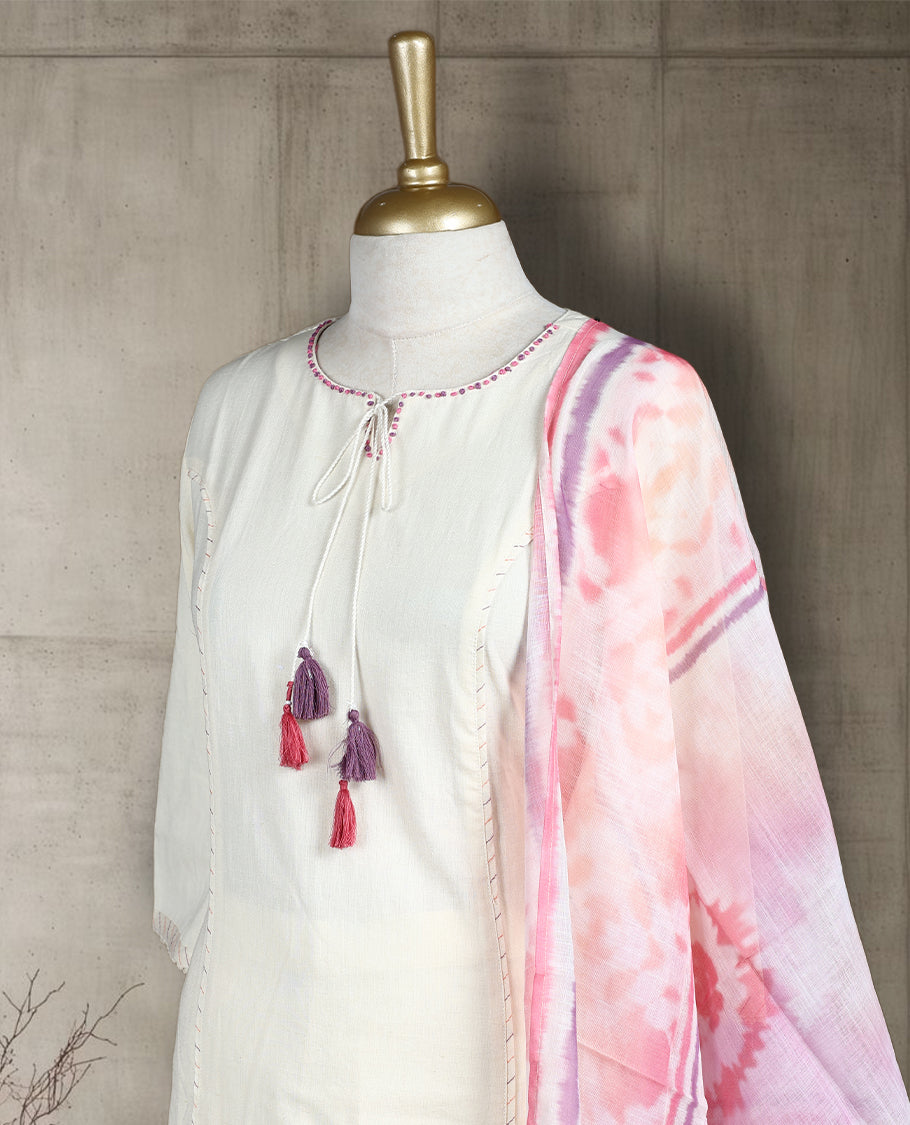 Off white colour salwar from TWARA, featuring a delicate pink & purple embroidered neck with thread work, paired with a matching bottom and an pink floral printed dupatta.