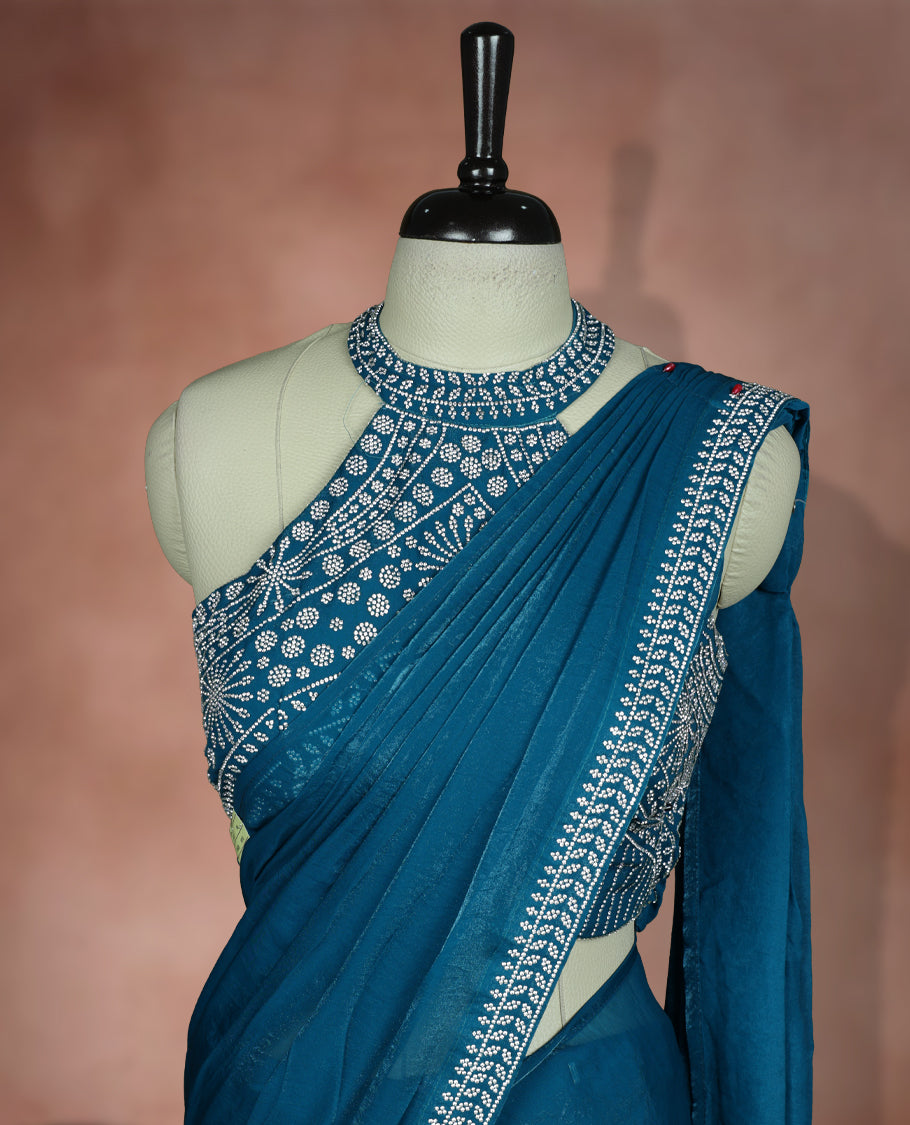 Elegant Aqua blue colour ready to wear saree adorned with rich white stone embroidery along the border and pallu, paired with a heavily embellished matching blouse for a grand festive look.