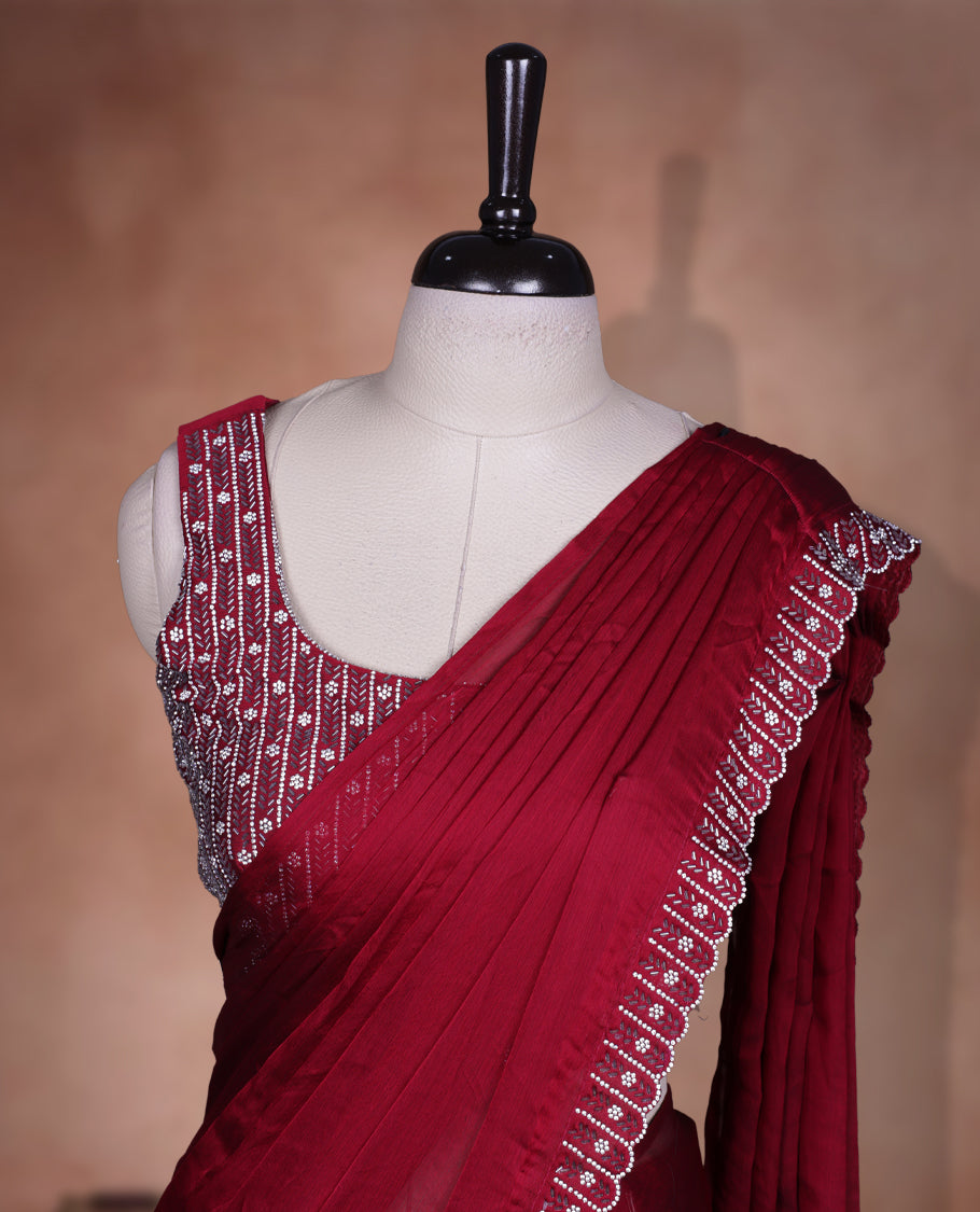 Elegant Dark red colour ready to wear saree adorned with rich White stone and bead embroidery along the border and pallu, paired with a heavily embellished matching blouse for a grand festive look.
