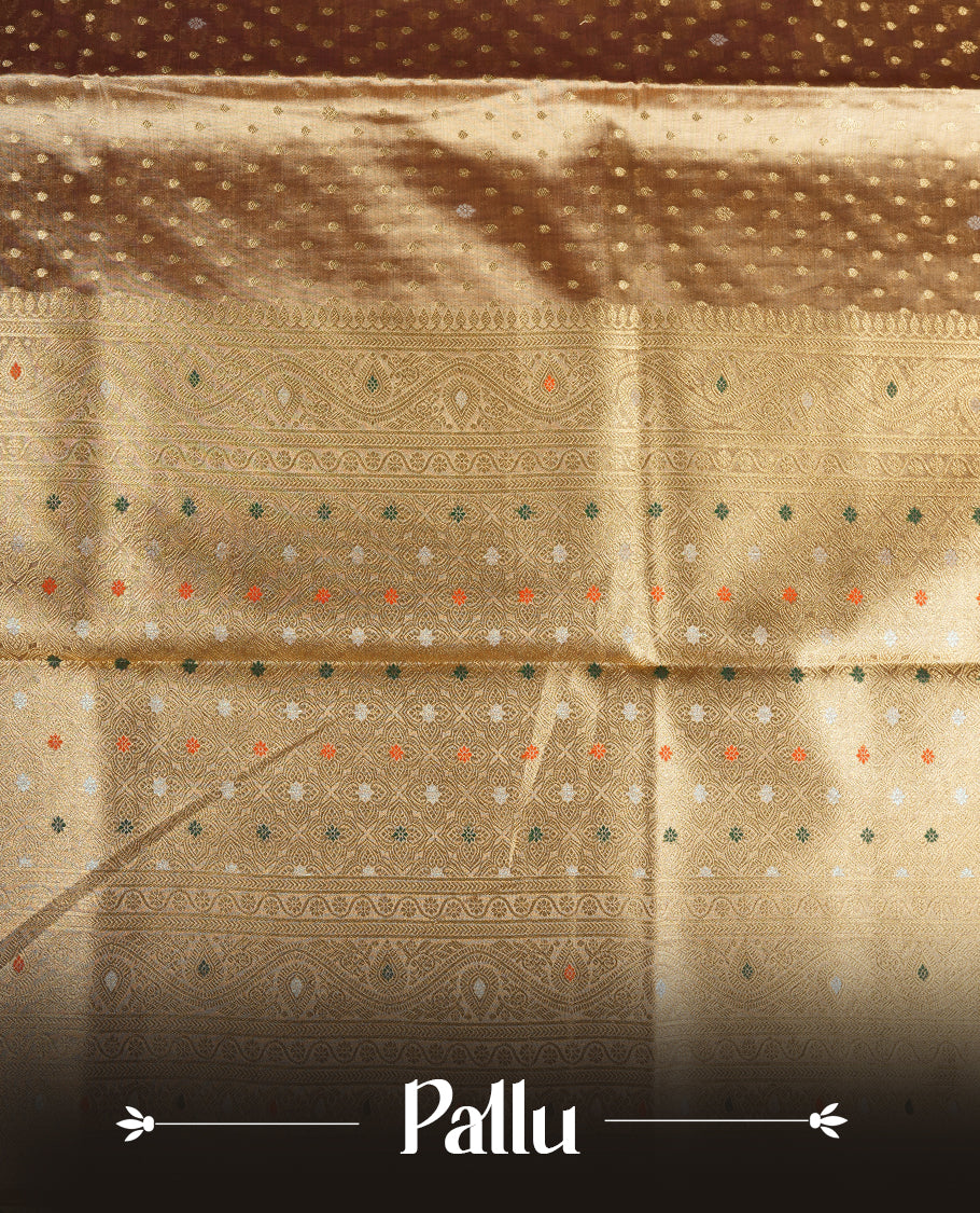 Antique gold colour tissue banaras silk saree featuring antique gold zari motifs on the body with rich traditional zari border and pallu, paired with a matching blouse piece.