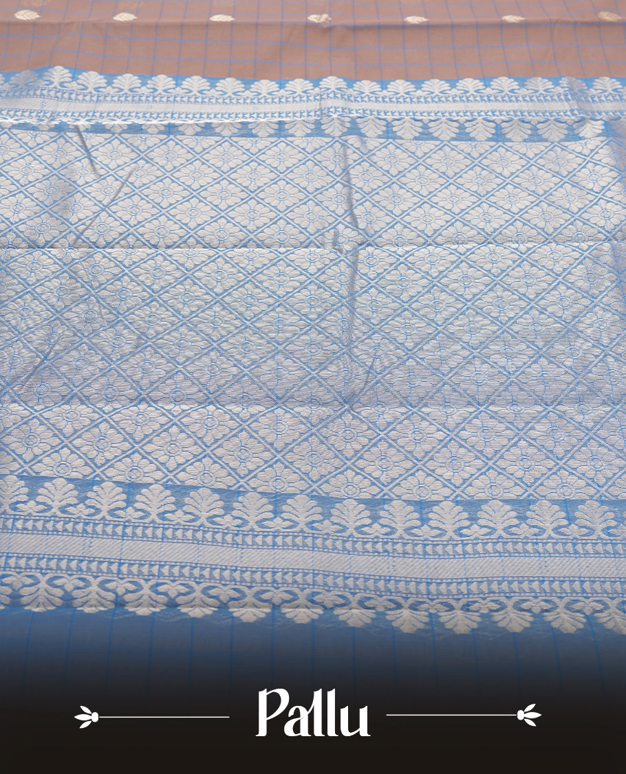 Beige Colour silk cotton saree with checkered body, scattered silver zari leaf buttas, ornate silver zari borders in teal green, diamond lattice pallu with temple motifs, teal green blouse with matching border.