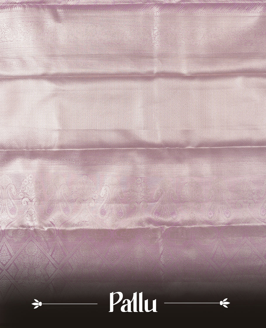 Light Lavender colour and silver Zari Tissue Brocade Saree features intricate Zigzag Motifs on body and self coloured border & pallu, paired with matching blouse