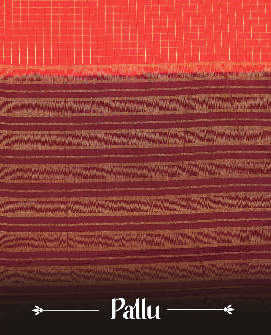 Red colour mysore crepe saree with gold zari check pattern on body, complemented by contrast Brown colour border featuring peacock and chakkram motifs, paired with matching blouse.