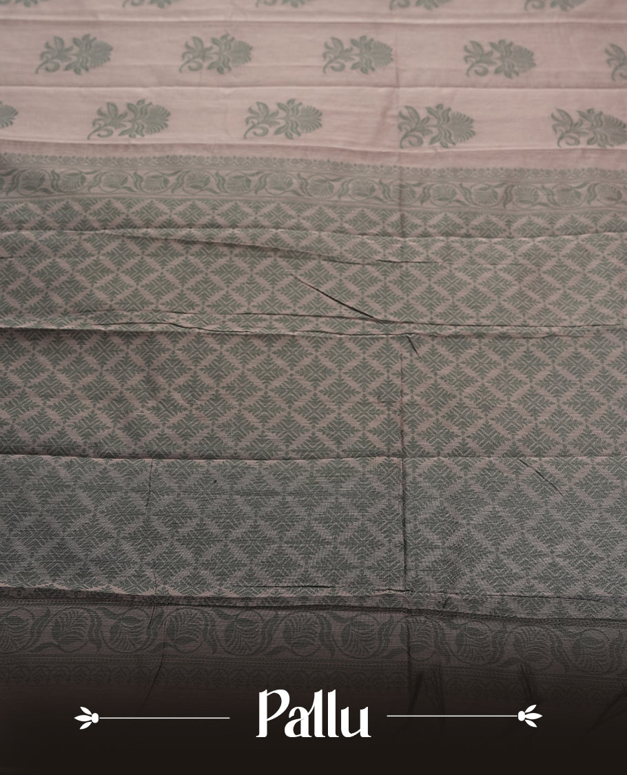 Dusty grey colour silk cotton saree featuring elegant floral zari motifs on the body, complemented by a rich contrast dark greenish border and pallu with traditional woven detailing & Comes with a matching blouse piece.