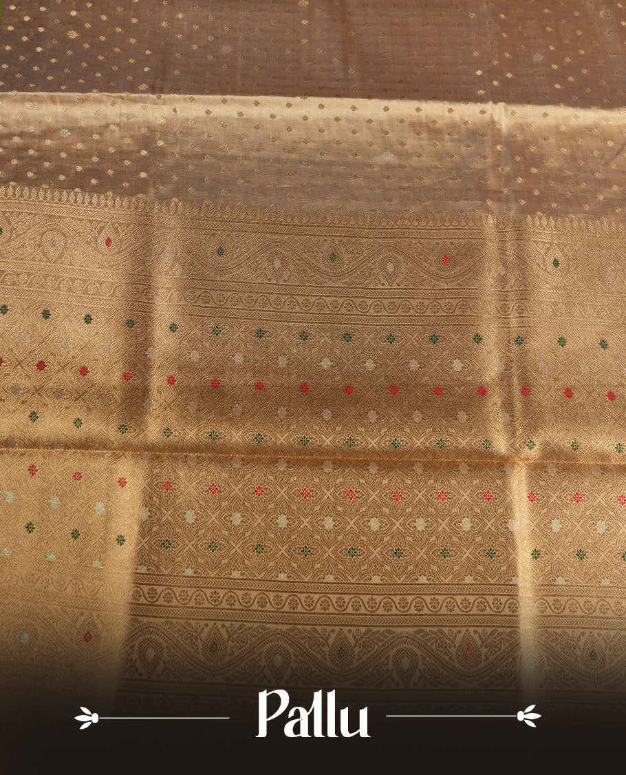 Light Gold colour tissue banaras silk saree featuring antique gold zari motifs on the body with rich traditional zari border and pallu, paired with a matching blouse piece.