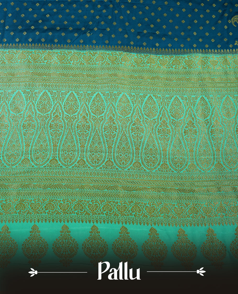 Dark Blue colour pure Banarasi georgette saree featuring gold zari Flower Motifs all over the body, complemented by an contrast sky blue dye colour with gold zari Floral Kodi Worked border and pallu, with matching blouse.