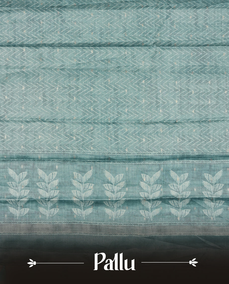 Aqua blue colour semi tussar saree adorned with Cream Zigzag printed pattern across the body and Leaf pattern on contrast aqua blue colour border, paired with a matching blouse.