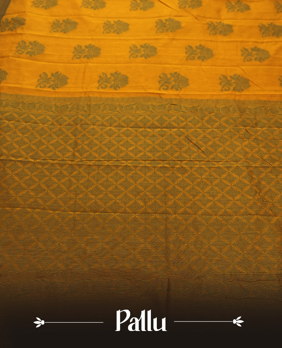 Mustard yellow colour silk cotton saree featuring elegant floral zari motifs on the body, complemented by a rich contrast dark green border and pallu with traditional woven detailing & Comes with a matching blouse piece.