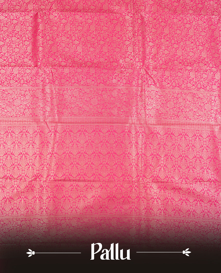 Rani pink colour semi silk brocade saree featuring intricate Gold Floral kodi patterns across the body, complemented by a rich self colour woven border and pallu, paired with a matching blouse.