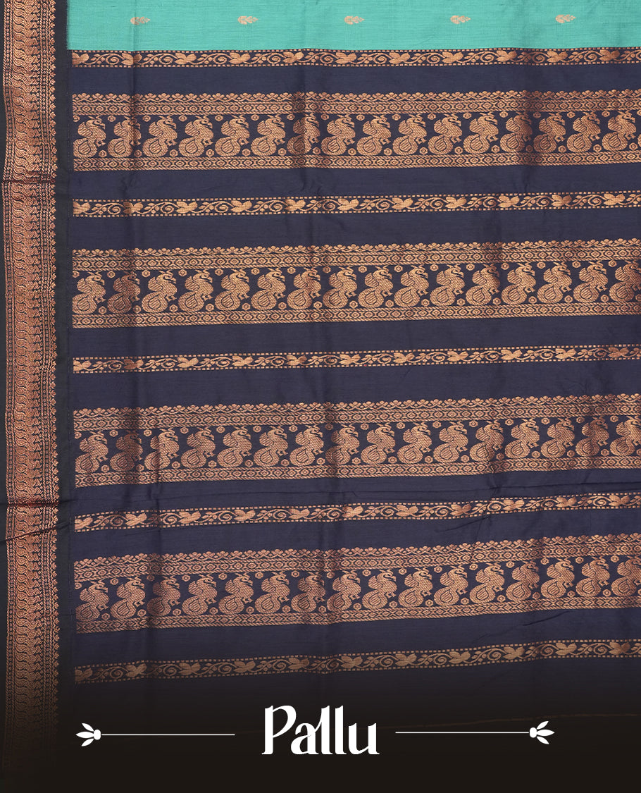 Sky blue colour Kalyani cotton saree with subtle zari motifs all over, paired with a contrasting rich navy blue copper peacock zari woven border and pallu & comes with a matching blouse piece.