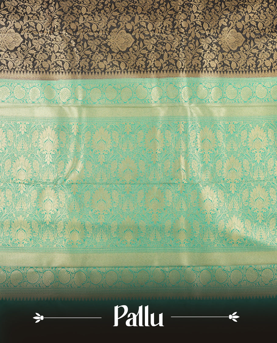 Dark Blue colour semi silk brocade saree featuring intricate Gold Floarl kodi patterns across the body, complemented by a contrast rich Aqua green colour woven border and pallu, paired with a matching blouse.