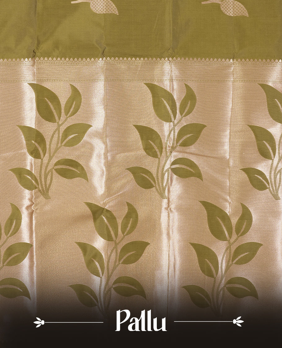 Olive Green colour Semi Silk Saree with Rose Gold Satin-Finish Pallu Featuring Bold Leaf Motifs, Geometric Zari Edging and Tassels, Paired with Coordinated Blouse Piece