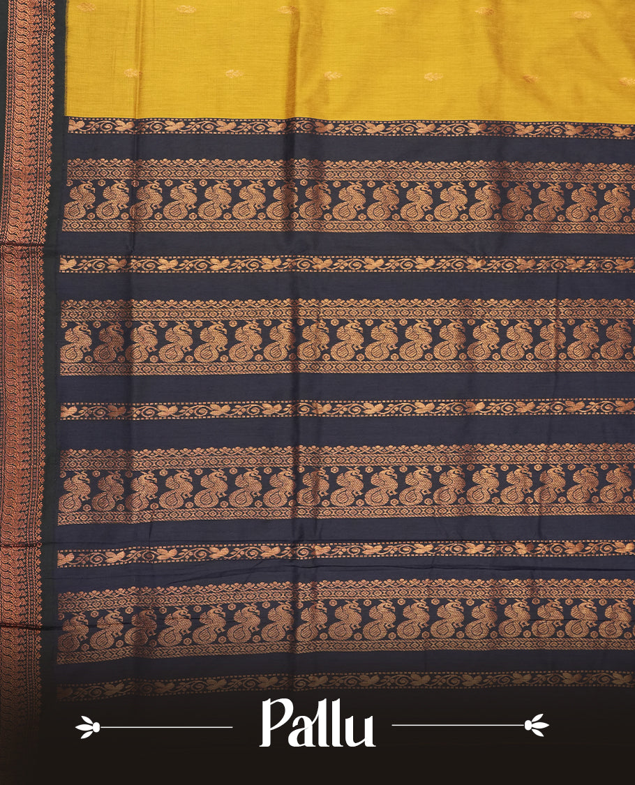 Golden yellow colour Kalyani cotton saree with intricate small motifs all over, paired with a contrasting navy blue rich zari woven border and pallu & Comes with a matching blouse piece.