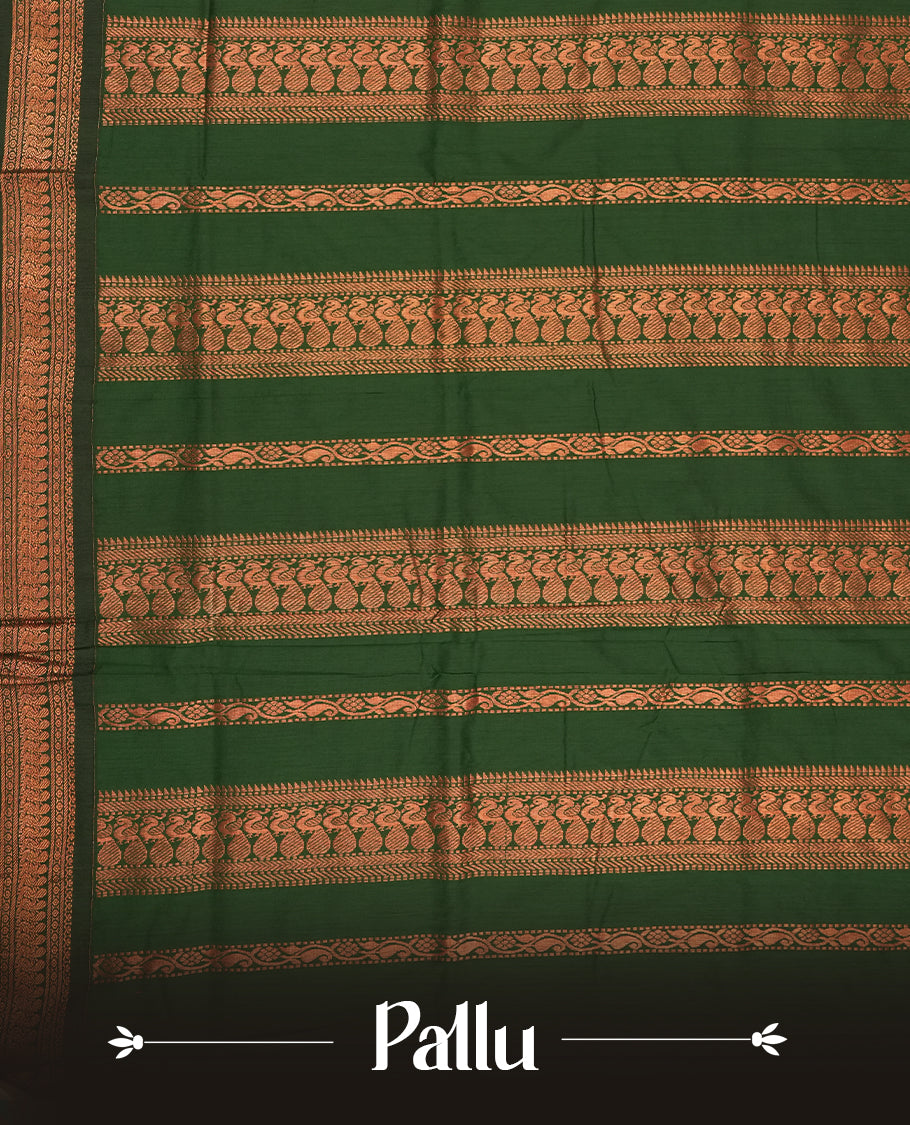 Maroon colour Kalyani cotton saree with subtle zari motifs all over, paired with a contrasting green rich copper zari woven border and pallu & comes with a matching blouse piece.