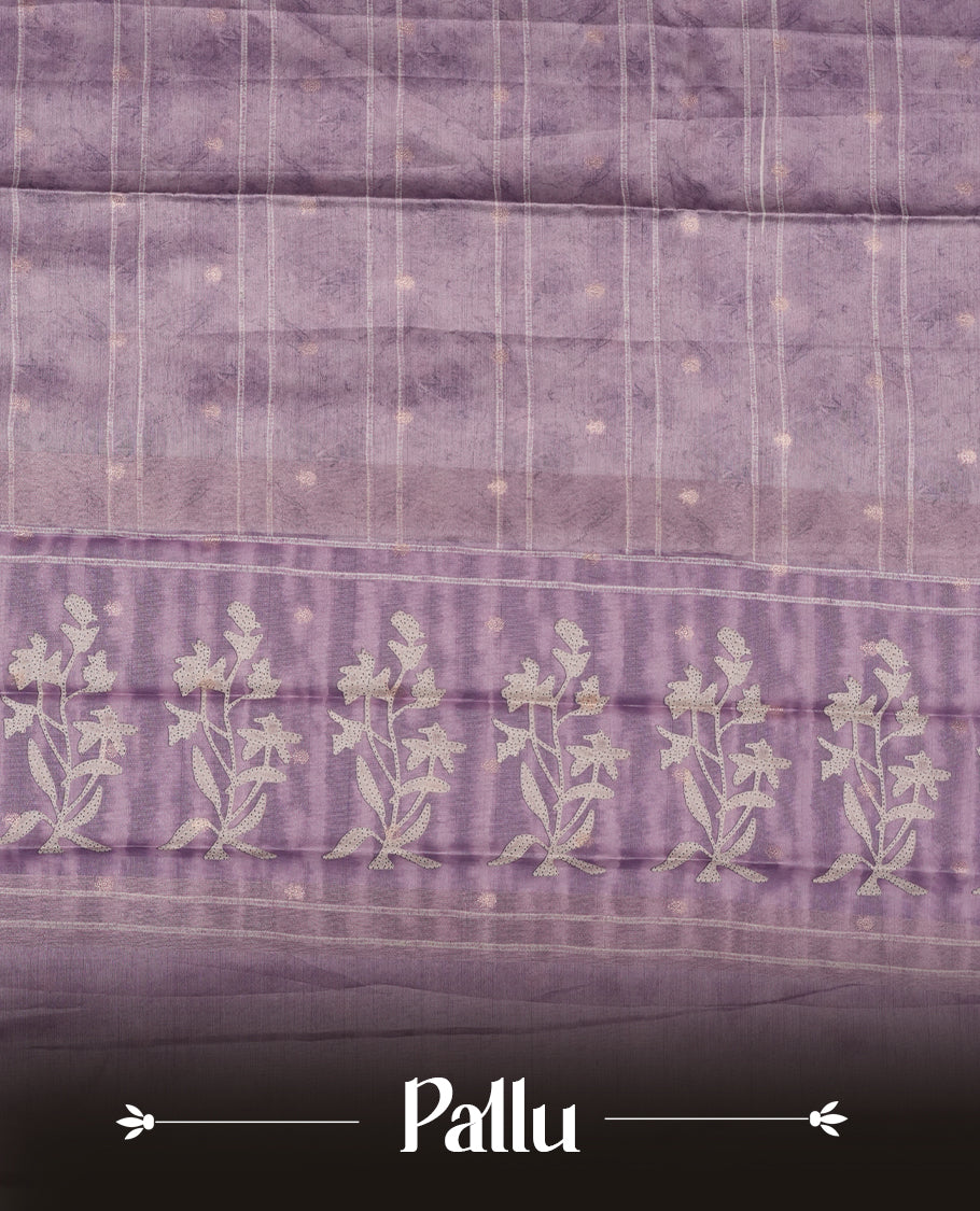 Light lavender colour semi tussar saree adorned with Cream strip printed pattern across the body, with cream Floral pattern on contrast Light purple colour border, paired with a matching blouse.