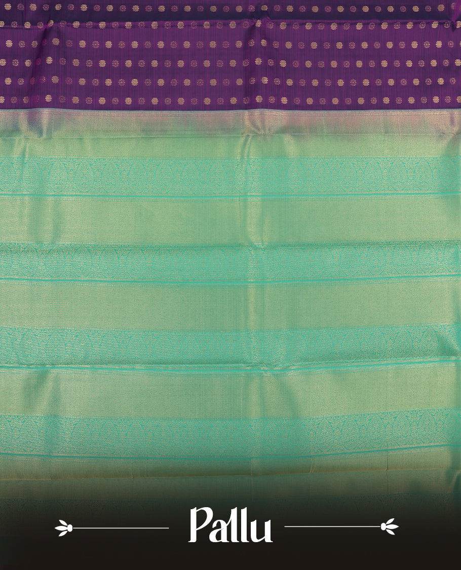 Very Dark purple colour semi soft silk saree featuring a gold coloured textured patterned body, complemented by contrast green with golden zari motifes on pallu & border and a matching blouse piece.