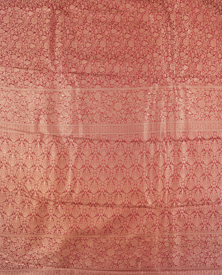 Deep Brown colour semi silk brocade saree featuring intricate Gold Floral kodi patterns across the body, complemented by a rich self colour woven border and pallu, paired with a matching blouse.